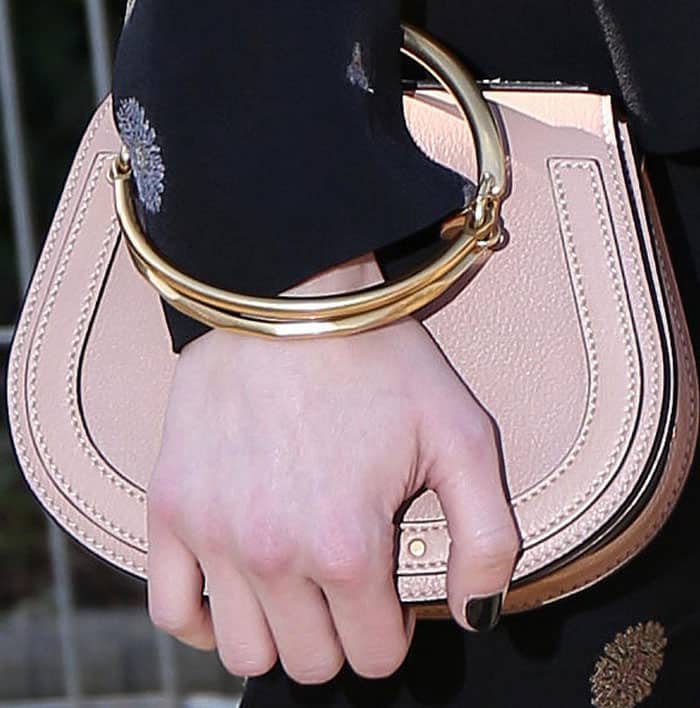Emma stylishly clutches her Chloé Nile bracelet bag